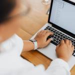 close up photo of a person typing on laptop